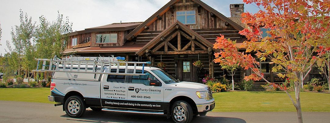 Purity Cleaning gutters on log cabin home in Bitterroot Valley