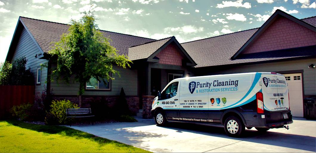 Purity Carpet cleaning van sitting in the driveway of a home